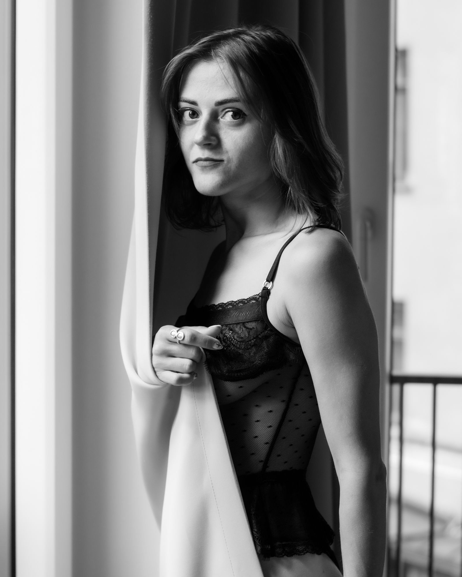 Black and white silhouette of a woman in soft window light